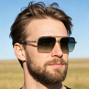 Detail of square pilot sunglasses with gold metal frame and double bridge on model