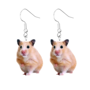 Macro shot of cute acrylic hamster earrings with realistic brown and white animal fur patterns