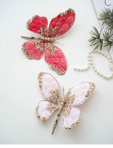Detail of velvet Christmas butterfly clip with gold glitter and white pearl beads