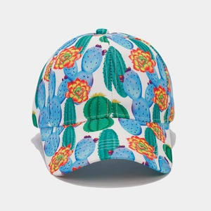 Detailed close-up of tropical cactus print on white fabric and precision stitching of the cap