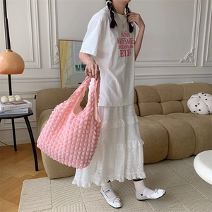 Detail of pink bubble texture tote bag showing 3D knitted fabric and soft surface