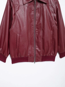 Detail of burgundy PU leather jacket featuring vintage ribbed hem and metal zipper closure