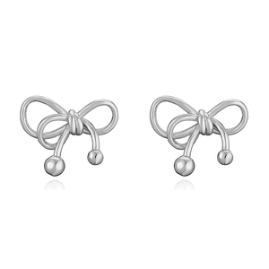 Detailed view of glossy silver bow-knot stud earrings with metallic luster on white background