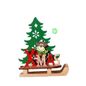 DIY wooden Christmas sleigh ornament with green tree and red XMAS letters on white backdrop