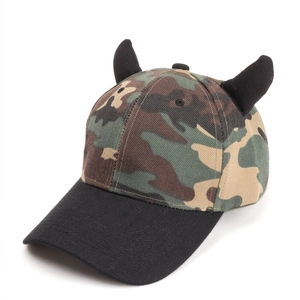 Macro shot of camouflage baseball cap featuring 3D devil horns and black brim detail