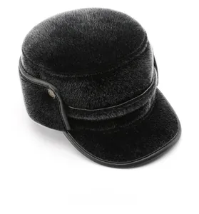 Detail view of the plush black faux fur top and brim of this warm winter flat cap