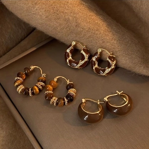 Vintage 14k gold plated tiger eye stone earrings collection on brown velvet display