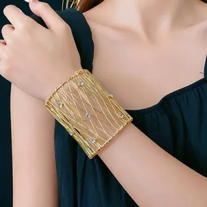 Gold wide woven mesh cuff bracelet with crystals in a luxury minimalist style