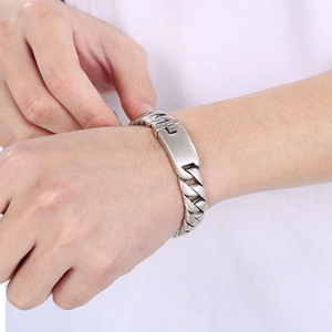 Close-up of vintage silver Cuban chain bracelet on male wrist with matte metal finish