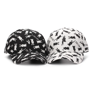 Detail of black and white baseball caps featuring rabbit patterns and LTRICH branding