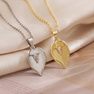 Minimalist gold and silver calla lily leaf necklaces with zircon on beige silk