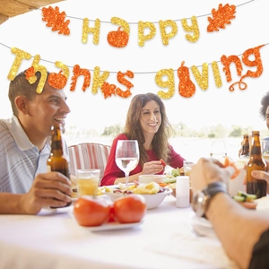 Glittery Happy Thanksgiving banner with maple leaf and pumpkin for party decor