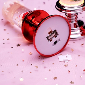 Close-up of the battery compartment and button cells on a red Christmas lantern base