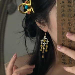 Detail of vintage star tassel drop earrings with colorful stones in Chinese style