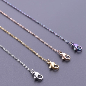 Close-up of stainless steel lip chains in silver, gold, rose gold, and rainbow finishes