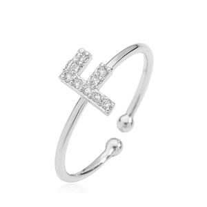 Detail of silver letter F open ring with cubic zirconia stones and ball ends
