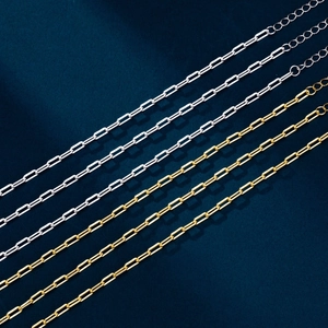 Detailed macro view of S925 sterling silver paperclip chains in gold and silver finishes