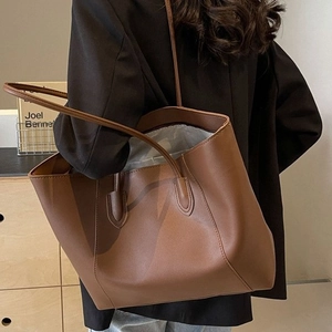 Brown faux leather tote bag for women shown with model in stylish black blazer