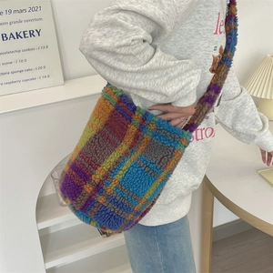Detail of colorful plaid faux fur tote bag with thick plush texture and shoulder strap