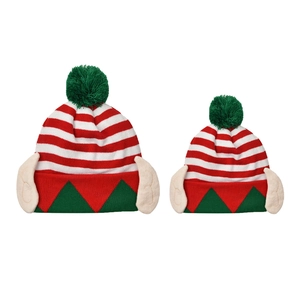 Detail view of two striped Christmas elf knit hats with green pom-poms and ears
