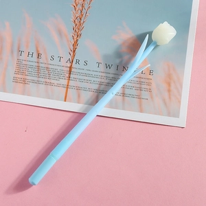Detail of rose floral pen with blue stem and white silicone flower on decorative card