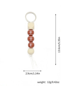 Detail showing dimensions and 12g weight of the rugby bead keychain with fringe