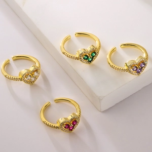 Macro detail of gold plated heart rings with colorful zircon stones and pave settings