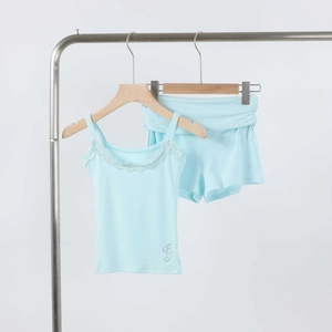 Detail of light blue home wear set featuring lace trim and rhinestone logo on fabric