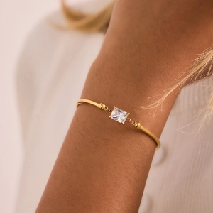 Close-up of 18K gold stainless steel bracelet with rectangular zircon stone on wrist