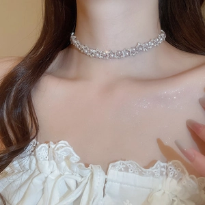 Close-up of manta rose pearl necklace with zircon detailing on model neck
