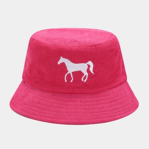 Detailed close-up of white horse embroidery on pink corduroy bucket hat texture
