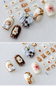 Detail of 3D bear and rabbit nail charms with bows applied on almond nail tips