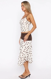 Detailed view of polka dot print two-piece set with irregular hem and camisole top
