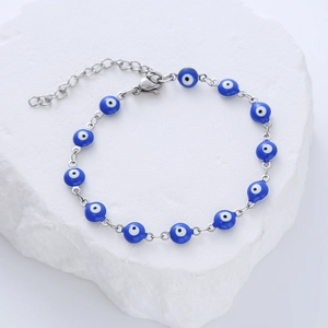 Detail of blue evil eye beads on adjustable stainless steel bracelet with lobster clasp