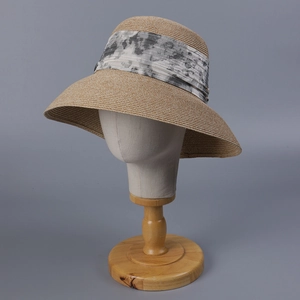 Elegant cloche straw sun hat with wide brim and decorative tie-dye ribbon for women