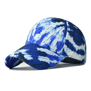 Detail of blue and white tie-dye cotton baseball cap with six-panel stitching and curved brim
