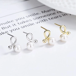 Detailed macro view of 925 sterling silver star pearl screw back earrings in gold and silver