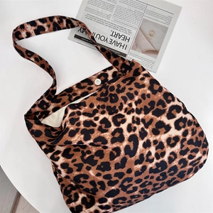 Macro shot of large leopard print tote bag interior with magnetic clasp and canvas lining