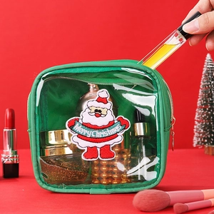 Detail of green Christmas makeup bag with Santa Claus embroidery and Merry Christmas text
