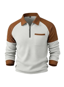 Detail of waffle knit fabric and contrast quarter-zip collar on men's polo sweatshirt