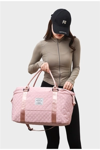 Quilted light pink travel bag with adjustable strap and large capacity for gym or yoga