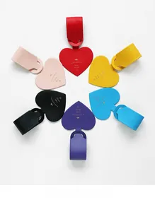 Colorful heart-shaped faux leather luggage tags in various vibrant shades with gold foil aircraft