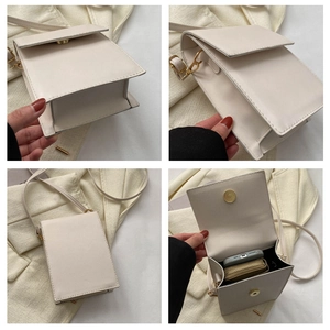 Detail view of cream-white crossbody phone bag with compartments and gold hardware