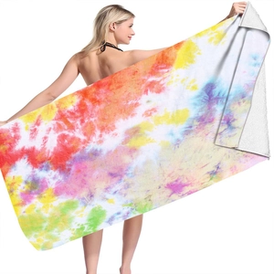 Detail view of large microfiber tie-dye beach towel with vibrant multi-color swirl pattern