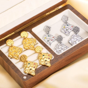 Lava-textured titanium steel earrings with colored diamonds in a premium wooden box