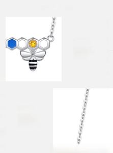 Detailed view of S925 sterling silver honeycomb necklace with bee and enamel accents