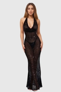 Detail of sheer black mesh dress featuring shimmering sequins and halter neckline