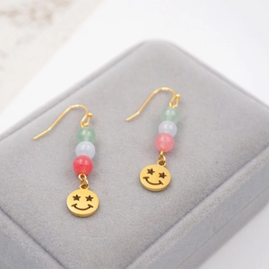 Ethnic style Joker mask earrings with green, white, and pink beads on a gold hook