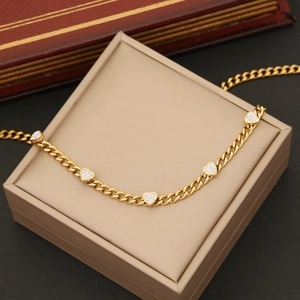 Gold-plated stainless steel Cuban link necklace featuring sparkling heart-shaped pendants