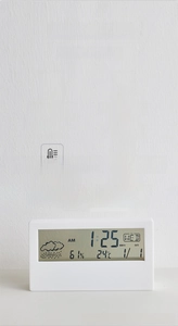 Detail of digital alarm clock showing LCD screen with time temperature and humidity